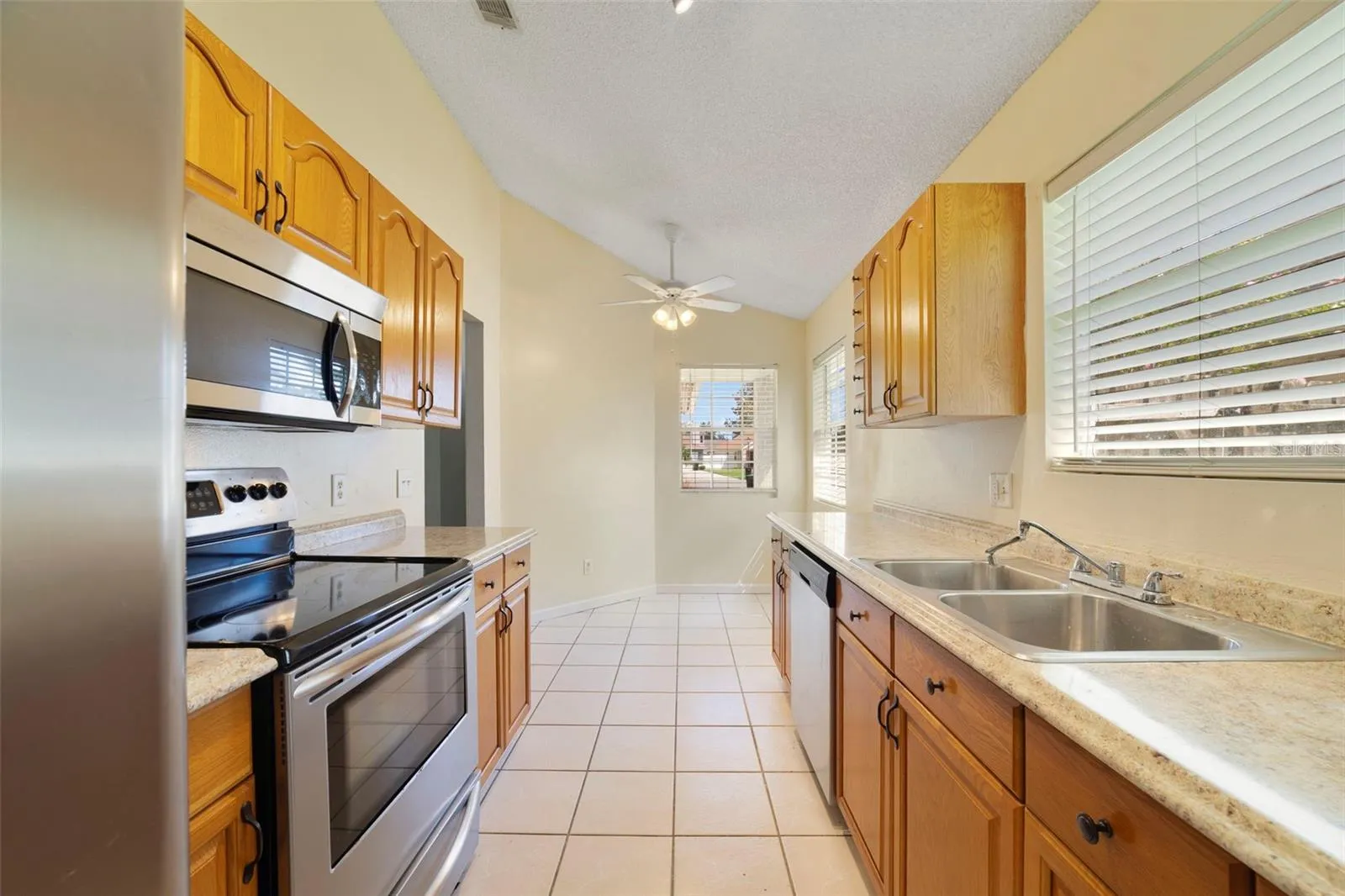 The Kitchen is conveniently located just off the main living spaces and features solid wood cabinetry, STAINLESS STEEL APPLIANCES, and a cozy, sunny BREAKFAST NOOK—a perfect spot for morning coffee or casual meals.