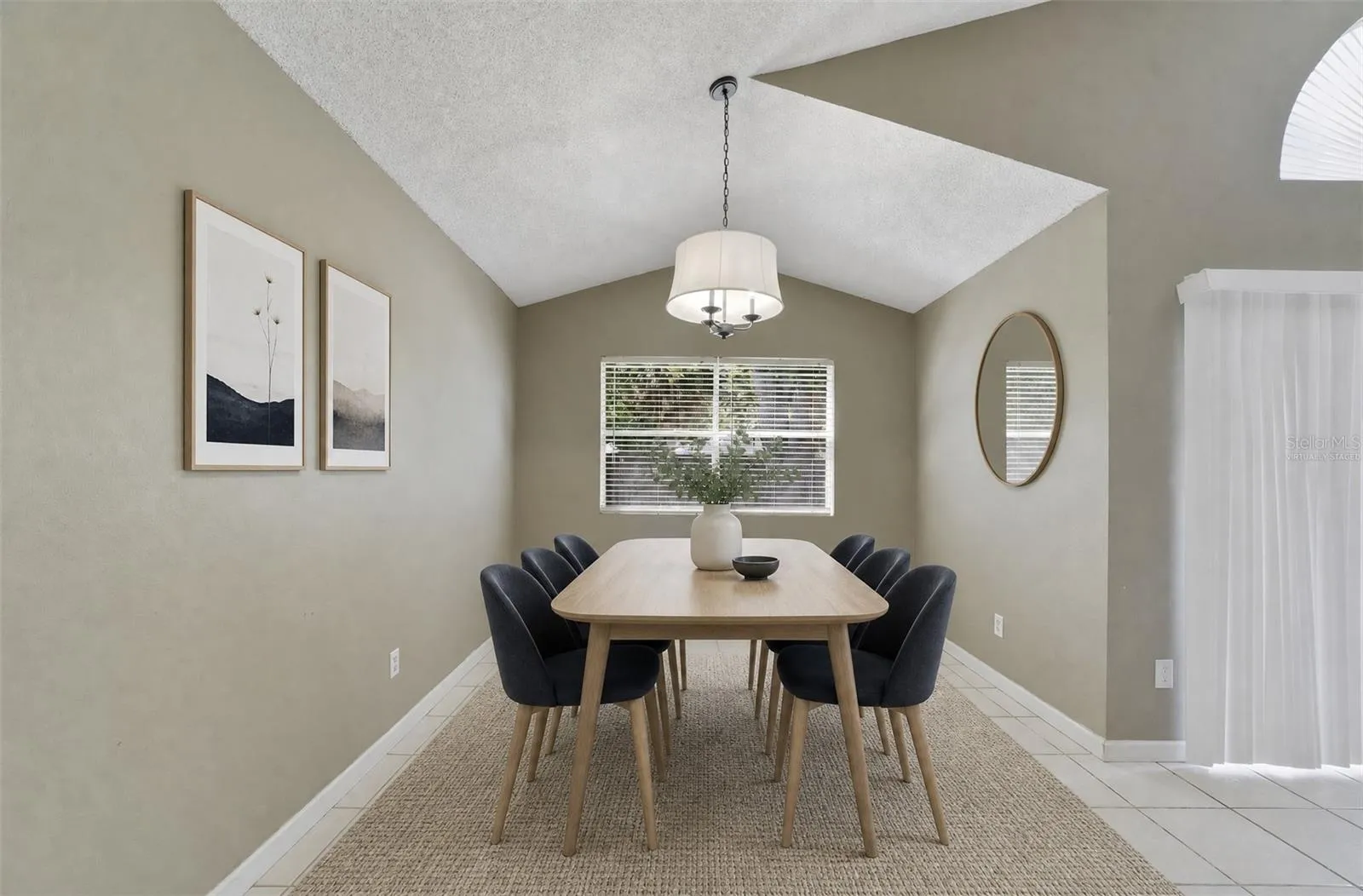 Nearby, the Dining Room enjoys a pleasant VIEW OF THE BACKYARD, and provides a comfortable setting for meals and gatherings. Virtually Staged
