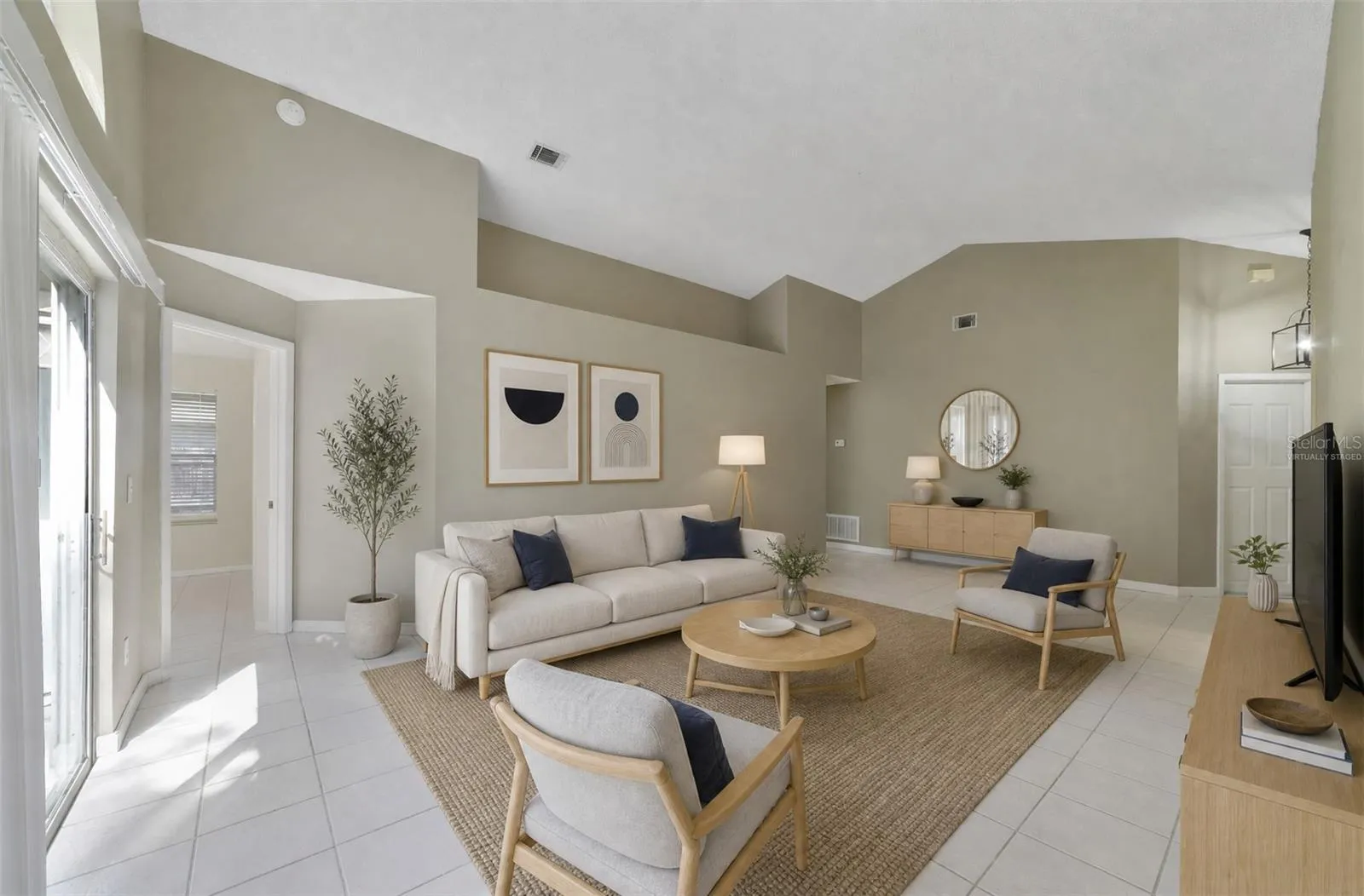 The spacious Living Room immediately catches your eye with its VAULTED CEILING, a unique decorative ledge and an ARCHED WINDOW positioned above the sliding glass doors that open to the back patio and SPACIOUS YARD, creating an easy connection between the indoor and outdoor spaces. Virtually Staged