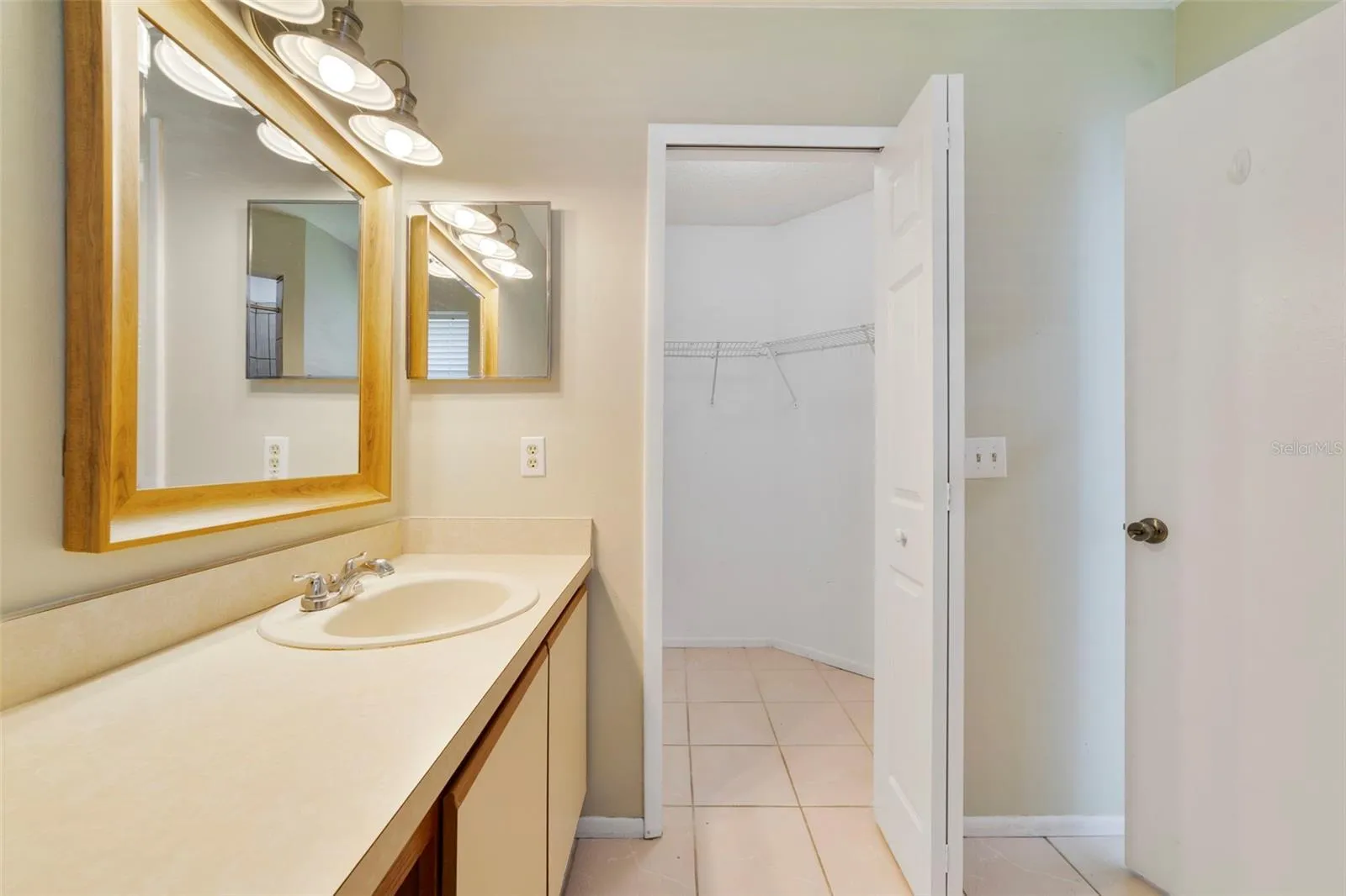 The Primary en-suite bath boasts a step-in shower, vanity with makeup space, and includes a LARGE WALK-IN CLOSET for convenient storage.