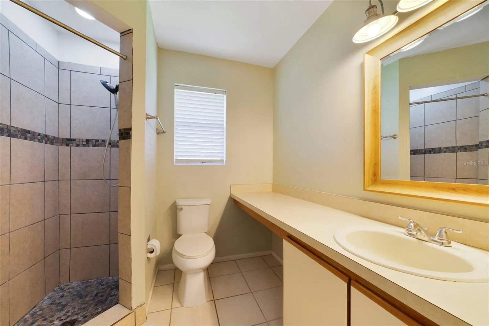 The Primary en-suite bath boasts a step-in shower, vanity with makeup space, and includes a LARGE WALK-IN CLOSET for convenient storage.