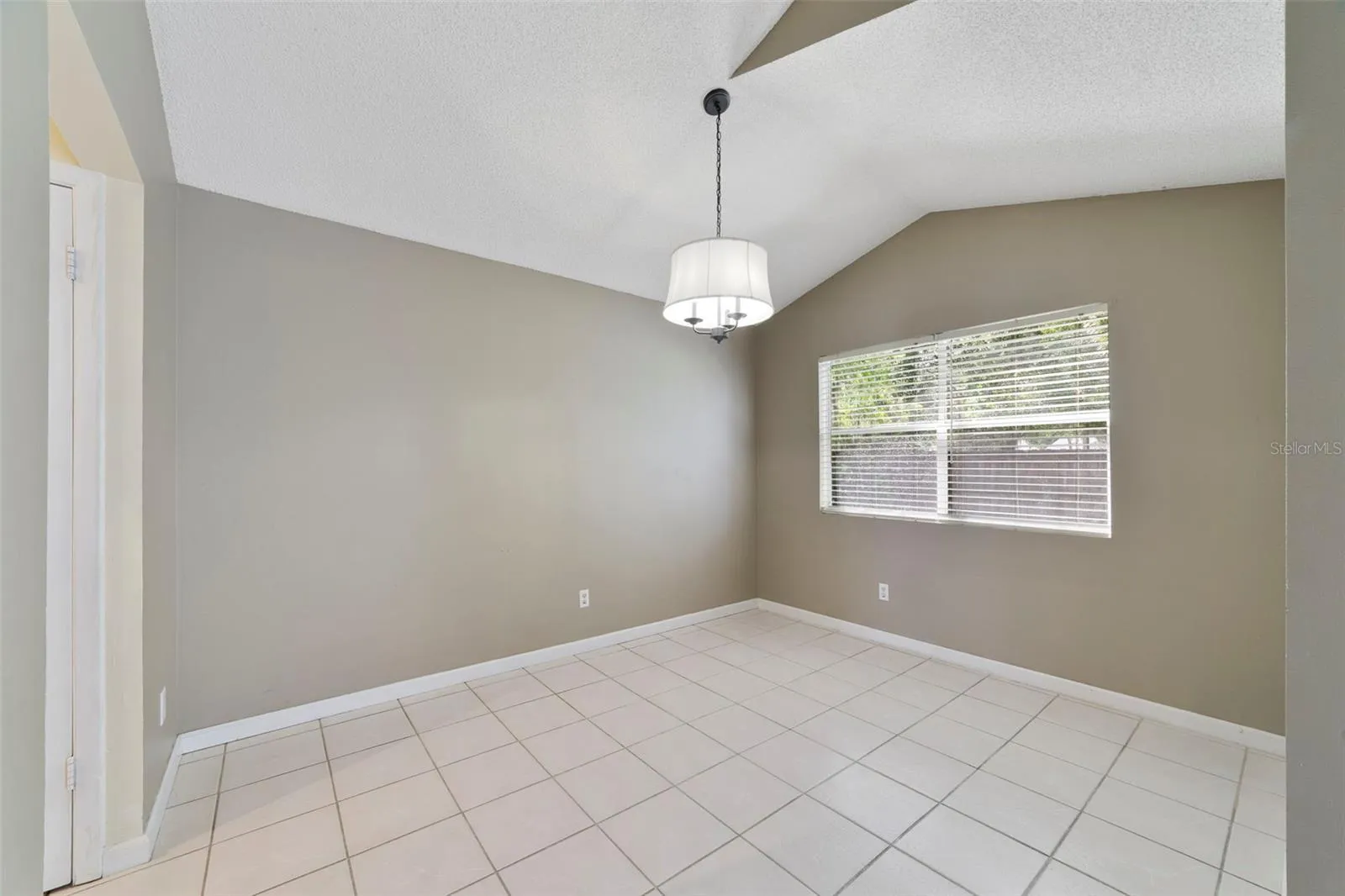Nearby, the Dining Room enjoys a pleasant VIEW OF THE BACKYARD, and provides a comfortable setting for meals and gatherings.