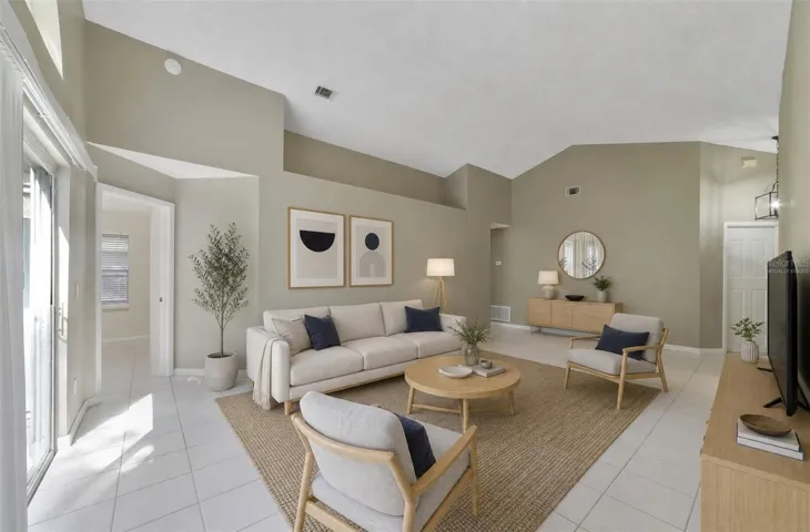The spacious Living Room immediately catches your eye with its VAULTED CEILING, a unique decorative ledge and an ARCHED WINDOW positioned above the sliding glass doors that open to the back patio and SPACIOUS YARD, creating an easy connection between the indoor and outdoor spaces. Virtually Staged