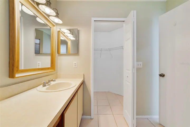The Primary en-suite bath boasts a step-in shower, vanity with makeup space, and includes a LARGE WALK-IN CLOSET for convenient storage.