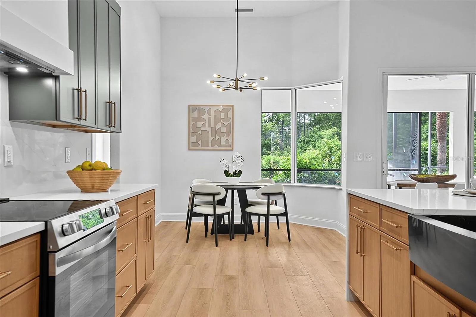 The kitchen looking out at the cozy breakfast nook that extends a beautiful view of the outdoors while you have your morning coffee or your casual dining.