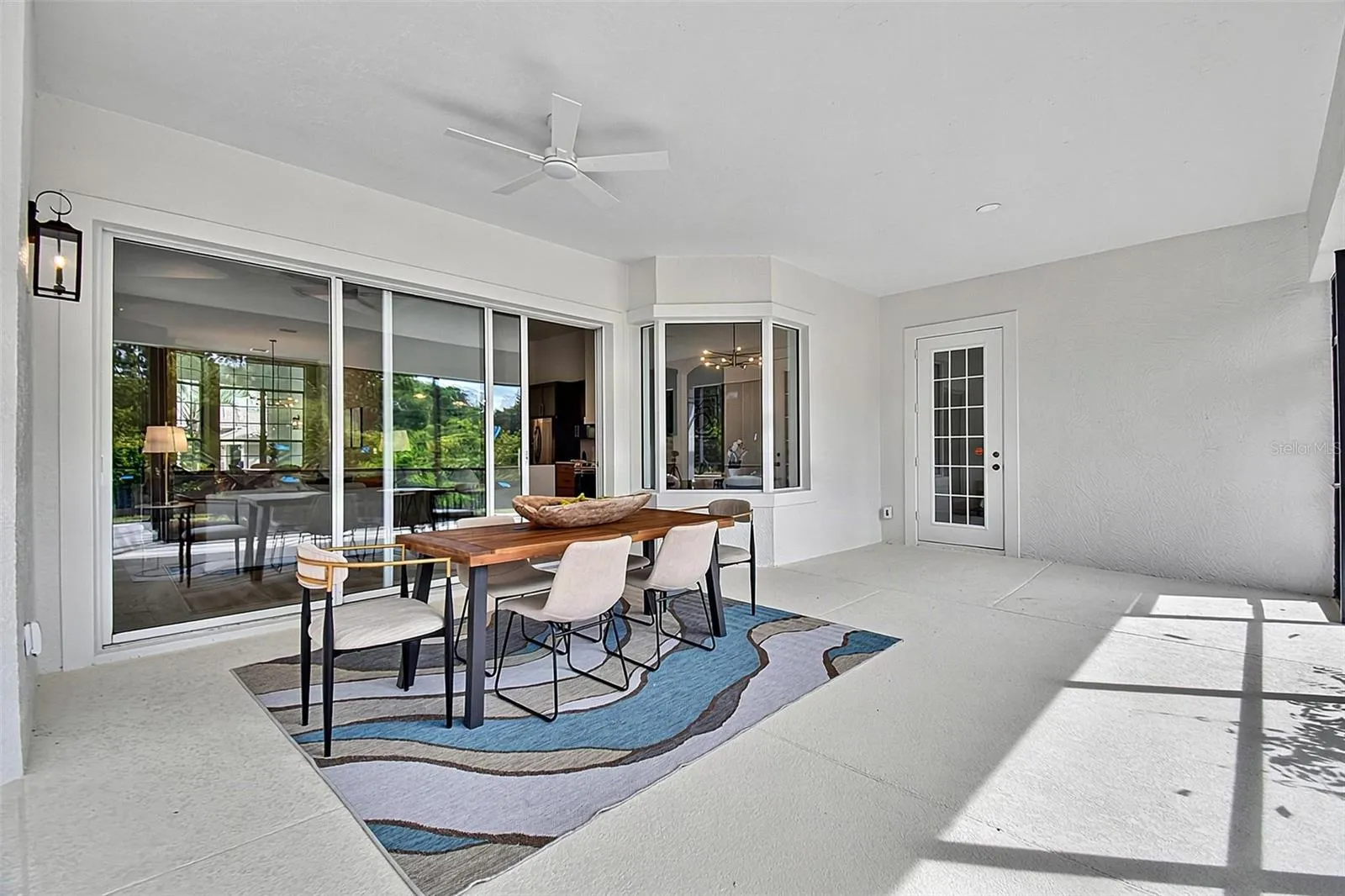 This shows the huge lanai with the triple sliders looking out into the home