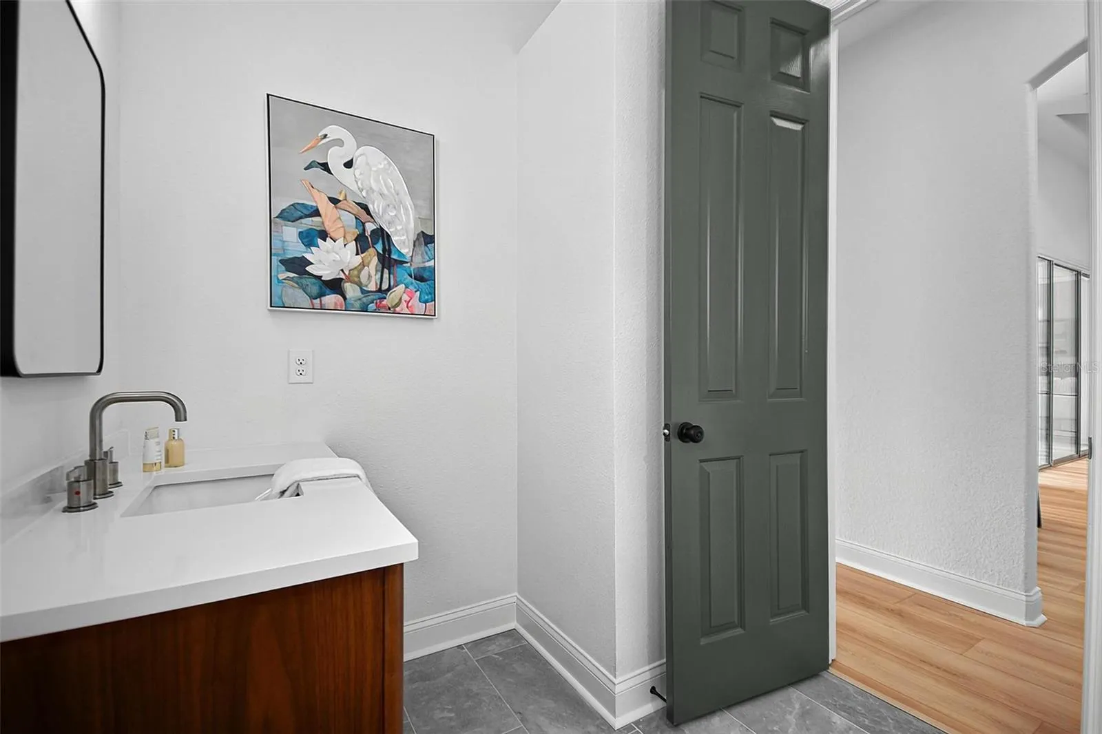The angle of the 2nd guest bathroom shows the linen closet space