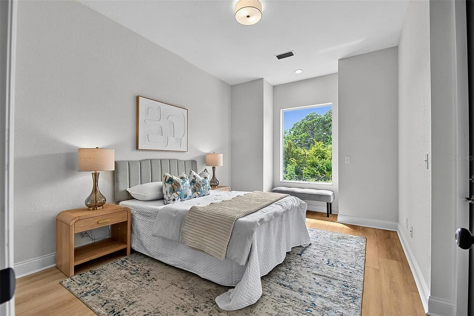 This spacious 3rd guest bedroom has a charming bench nook in the window and access through a back door to the huge covered screened lanai area..