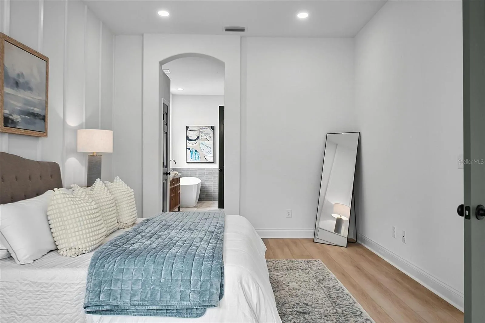 The master bedroom en-suite is framed by the curved door way.