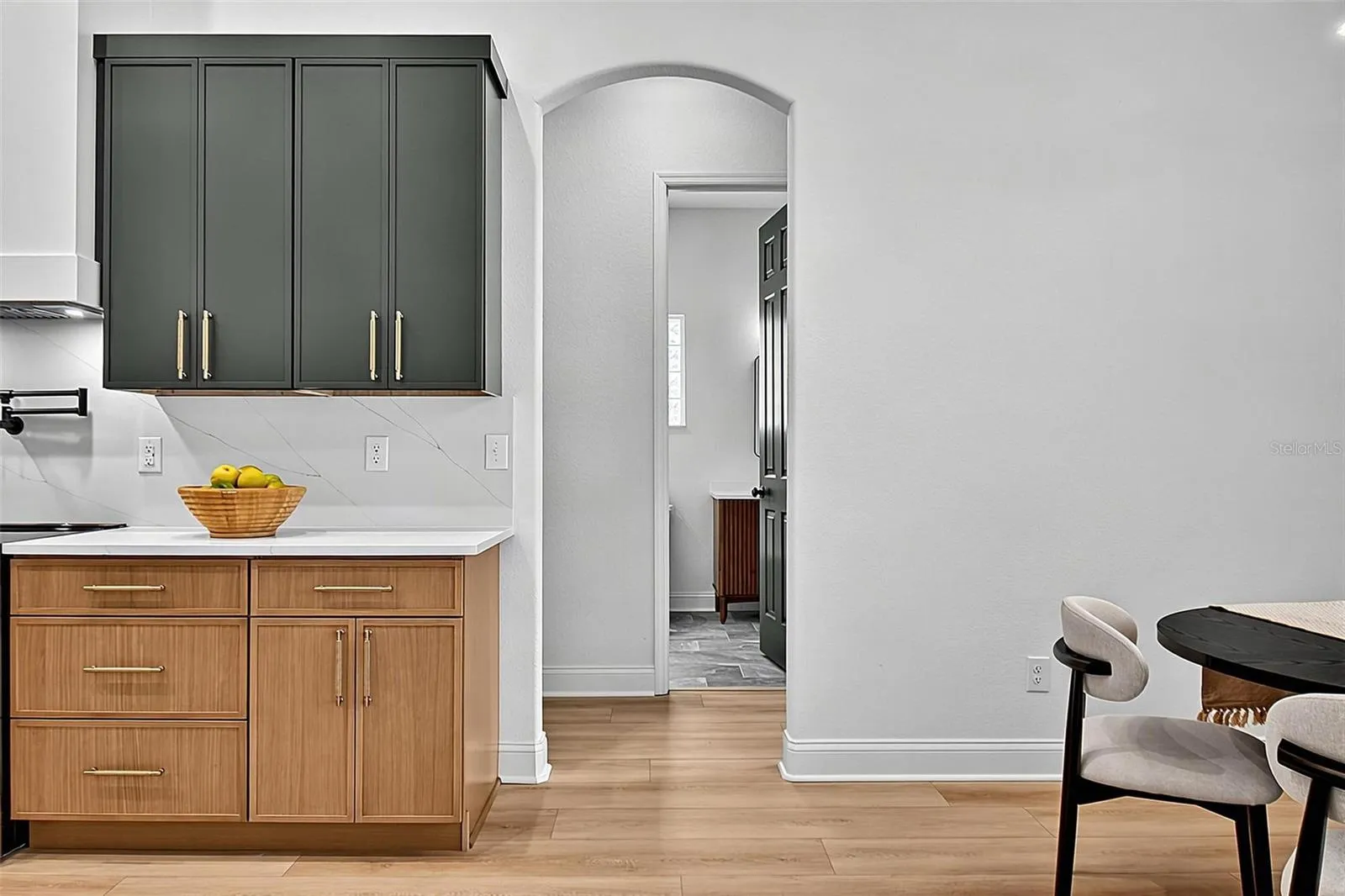 This kitchen look shows the gorgeous curve door frame leading into the hallway to the guest bathroom, 3rd guest bedroom