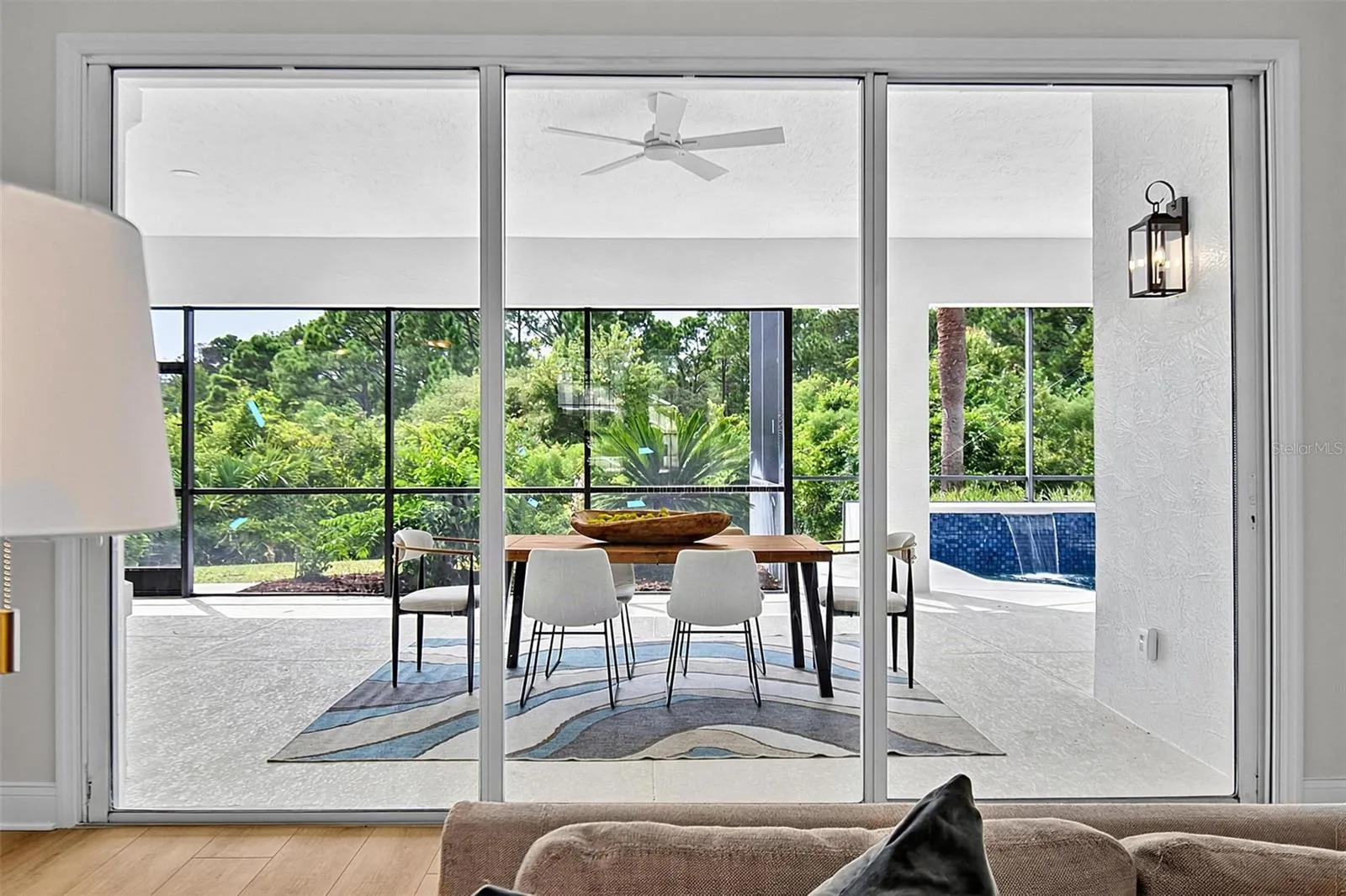 Triple sliders open up to the huge covered lanai from livingroom