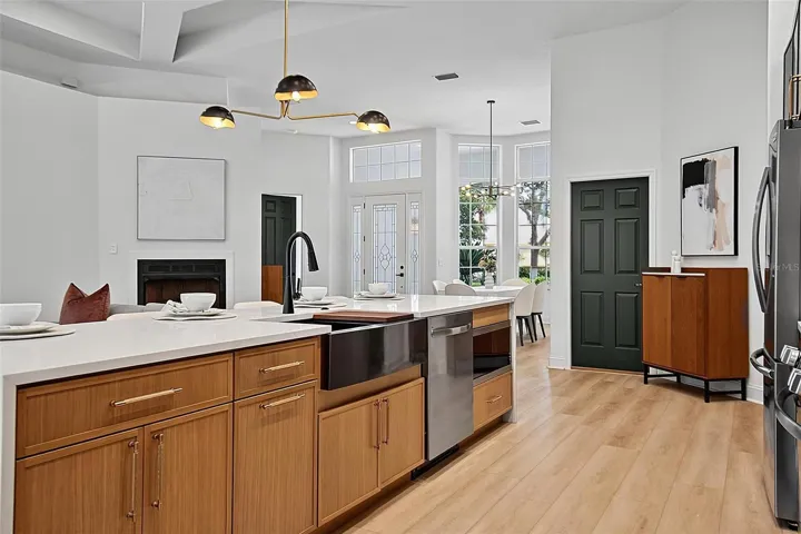 The beautiful crafted wood cabinets frame the sleek design of the black fixtures, farm house sink, inset microwave and dishwater.