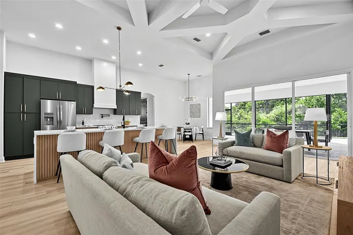 Step inside the open concept living room with the enormous high coffered ceilings that set the tone for the living room/dining room/ breakfast nook into a fully renovated kitchen that flows effortlessly together.