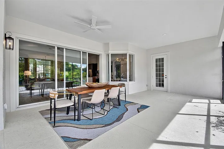 This shows the huge lanai with the triple sliders looking out into the home