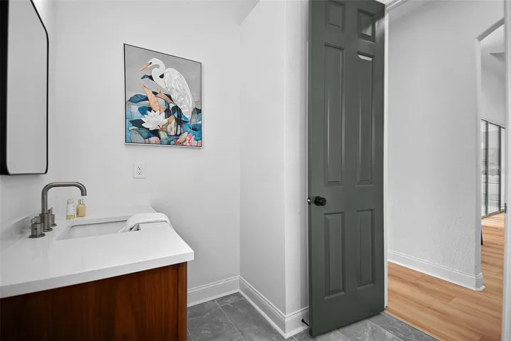 The angle of the 2nd guest bathroom shows the linen closet space