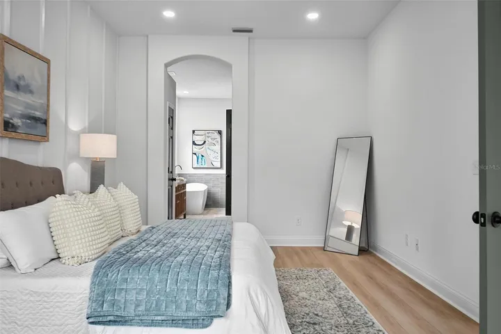 The master bedroom en-suite is framed by the curved door way.