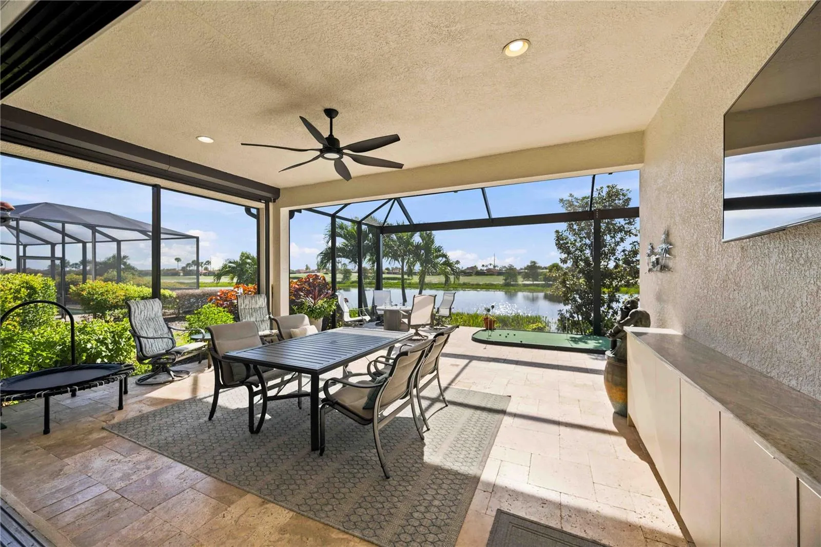 Extended lanai extends outdoor living - protected by two storm smart screens.