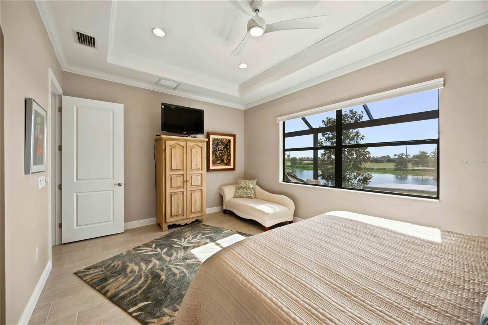 The primary bedroom is large and has lots of light overlooking the water - tile throughout.