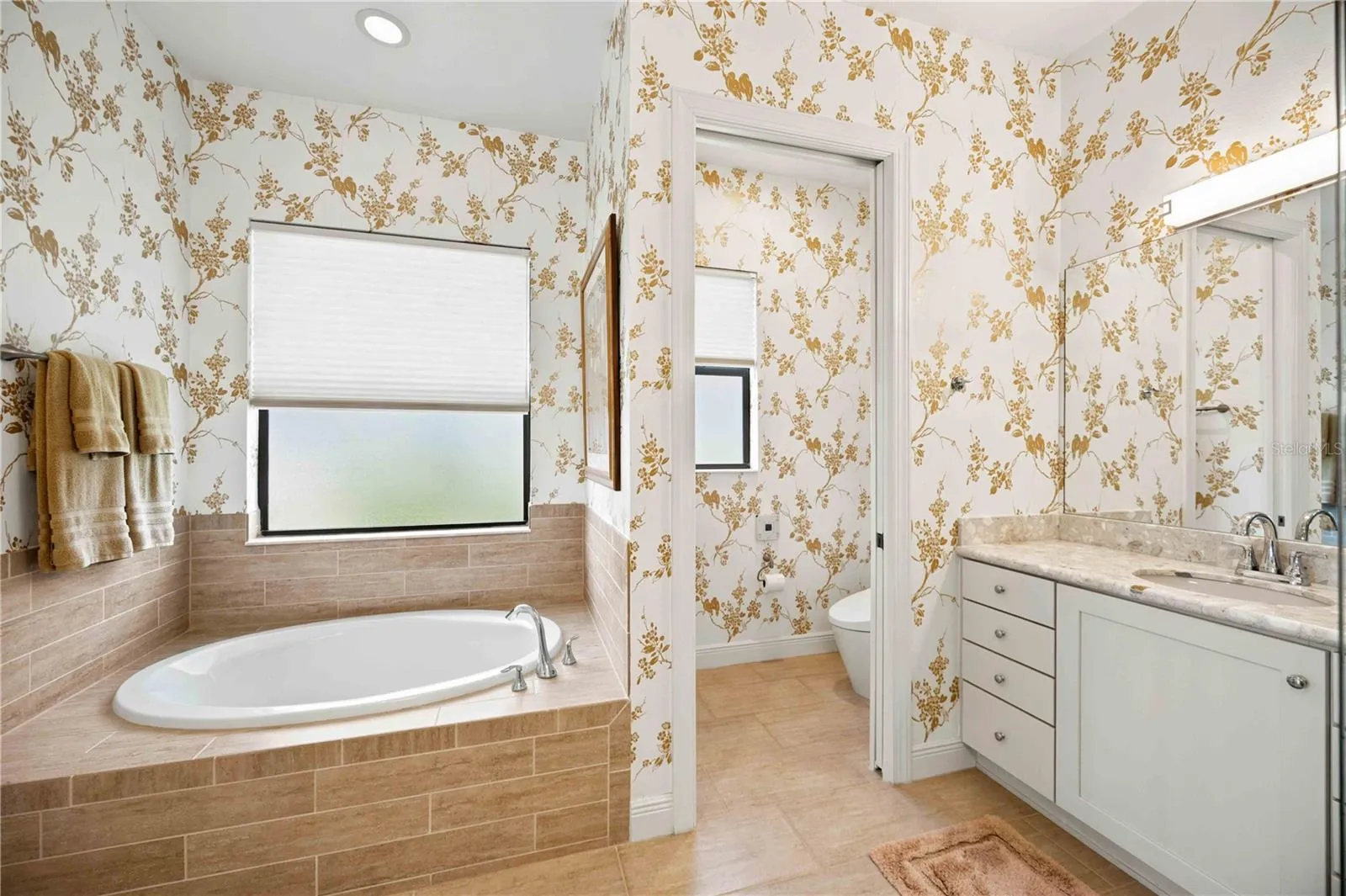 The primary ensuite has dual vanities, a large walk in shower, a soaking tub and private water closet.