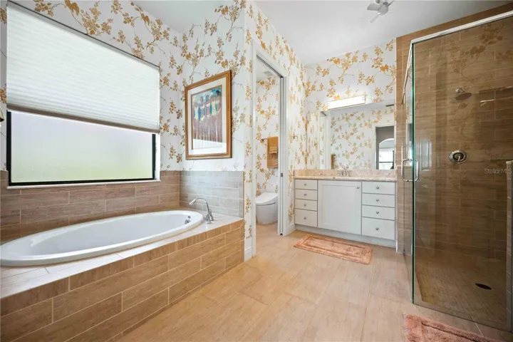 The primary ensuite has dual vanities, a large walk in shower, a soaking tub and private water closet.