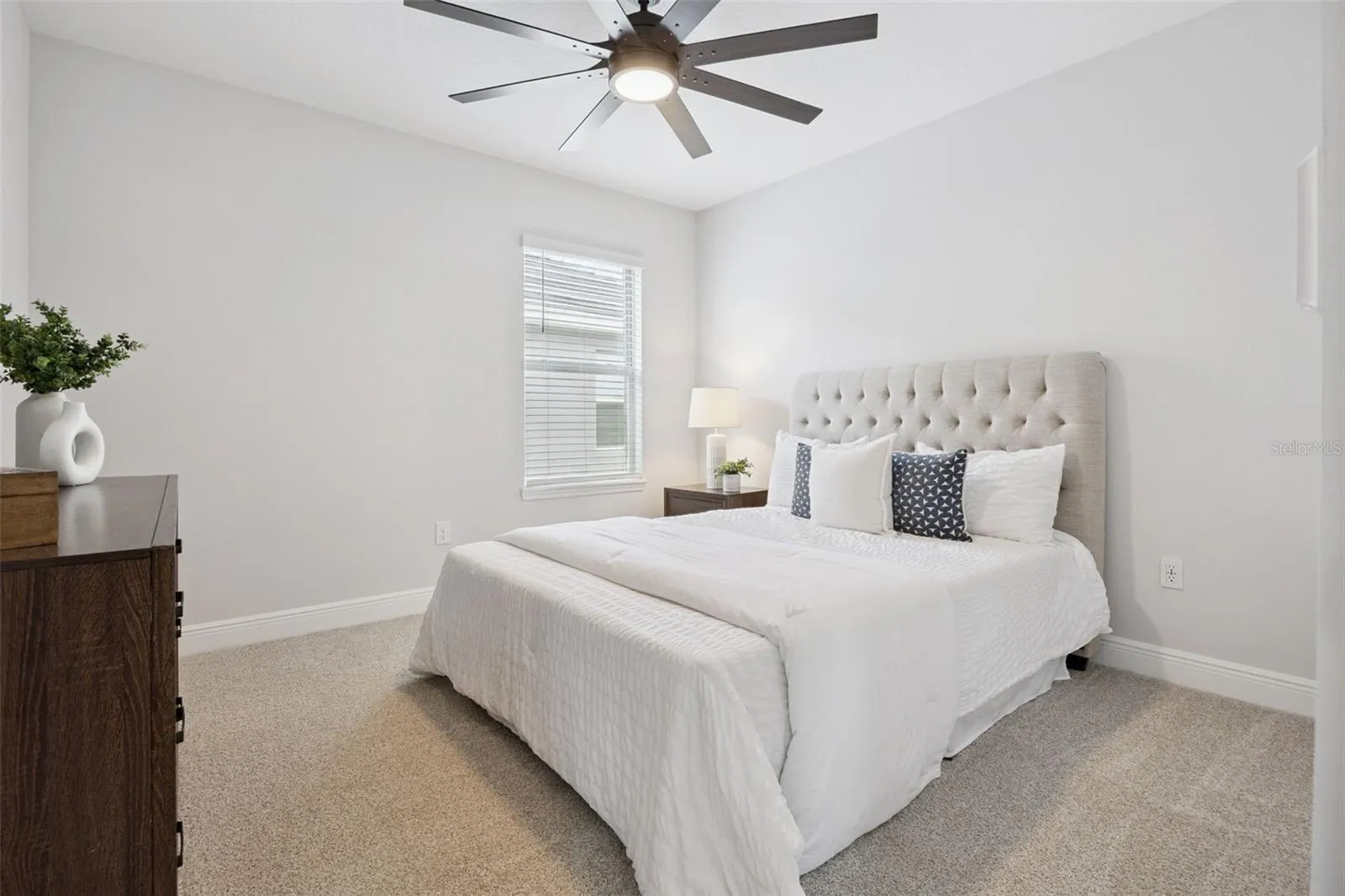 Bedroom with ceiling fan and built-in closet