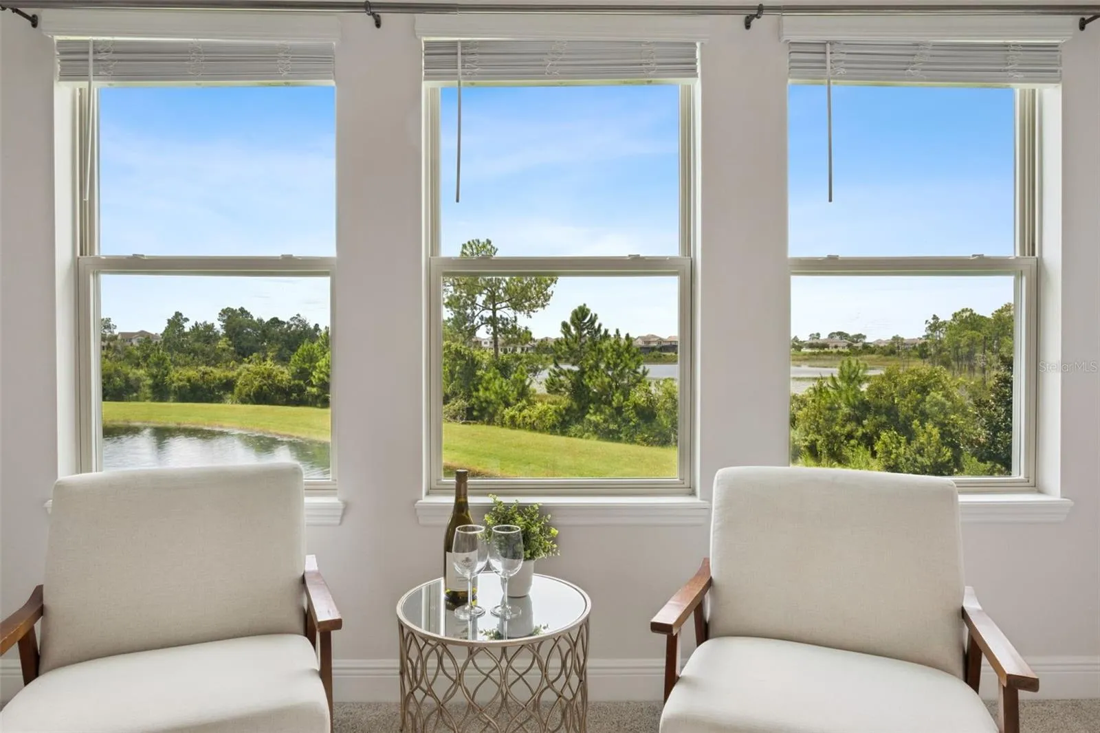 Pond-view windows frame the primary suite sitting area