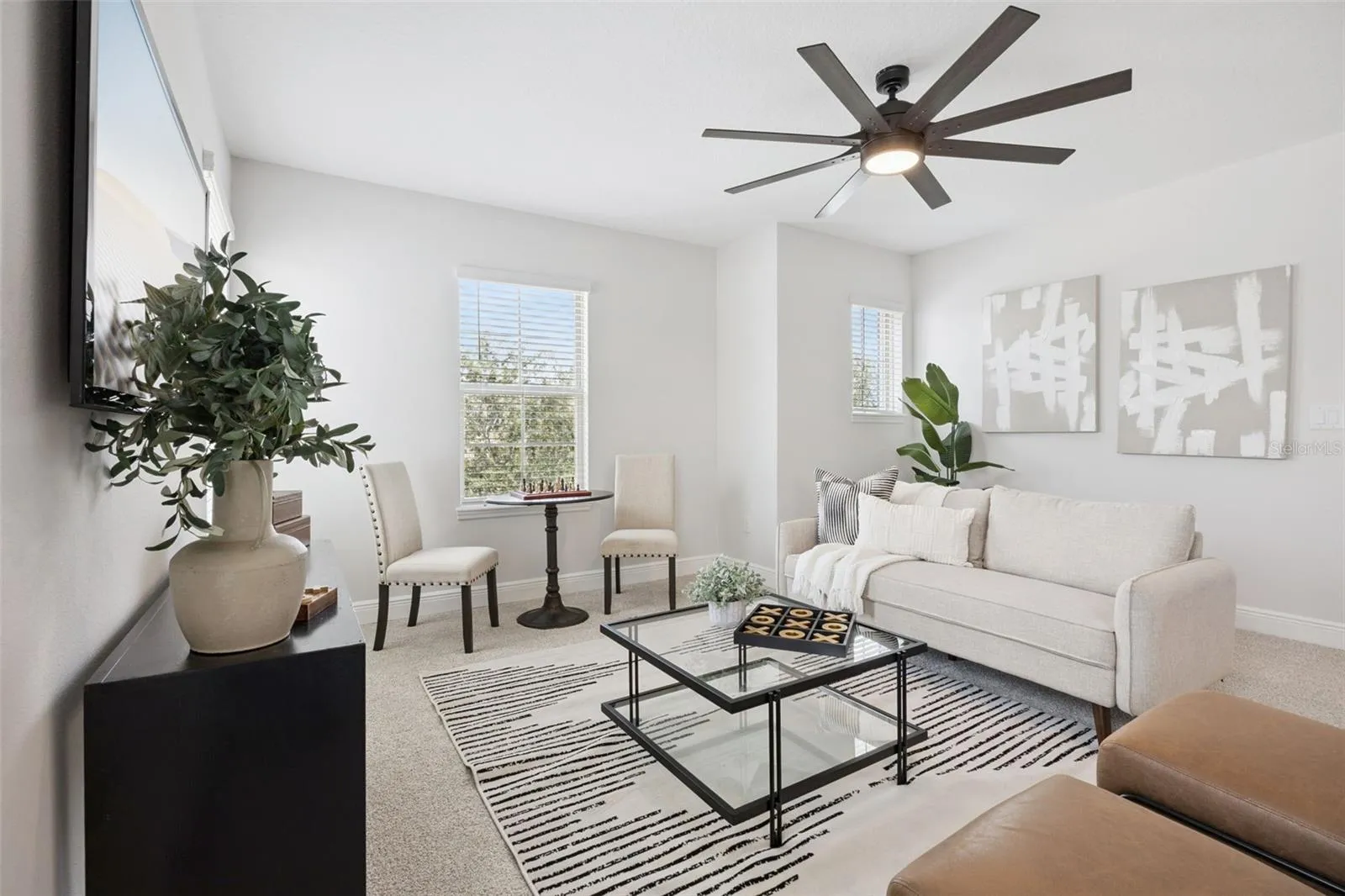 Second-floor loft with ceiling fan and natural light