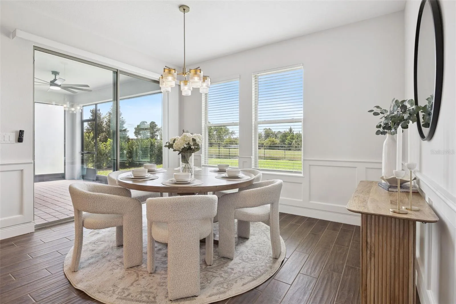 Dining room with chair rail, water views, and lanai access
