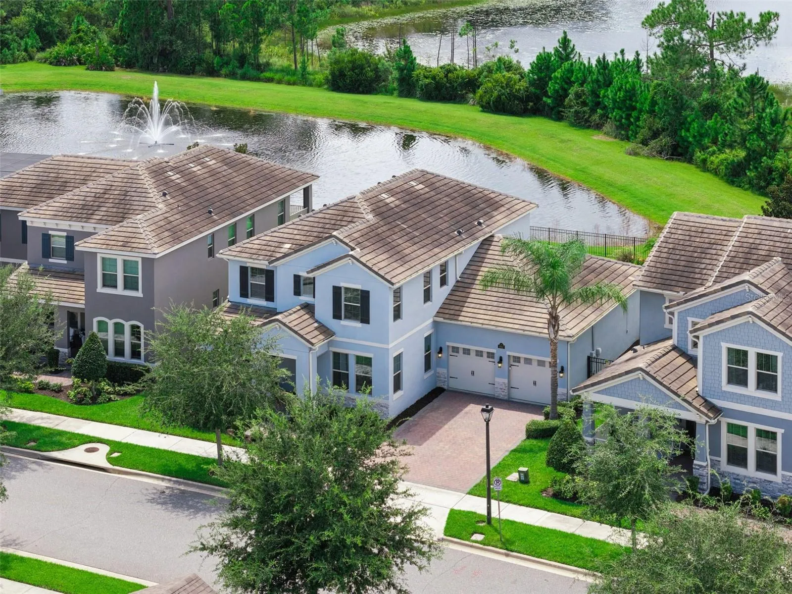 Aerial front view of the home and tree-lined street