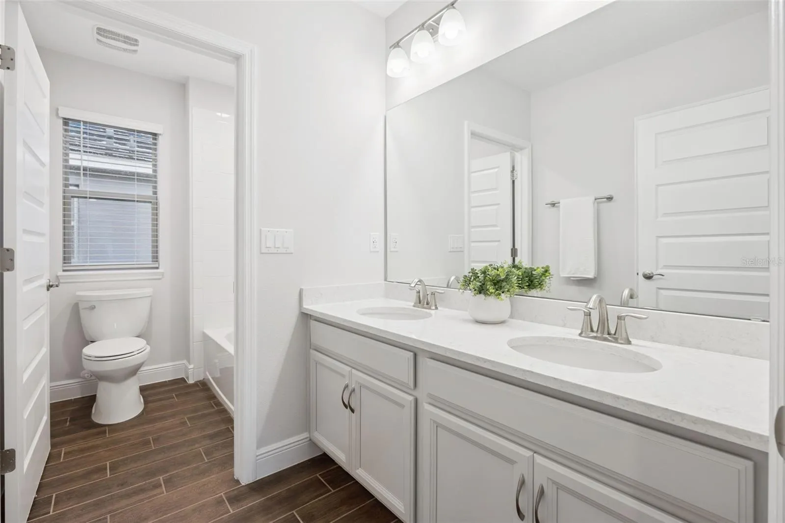 Second-floor full bath with dual-sink vanity and linen closet