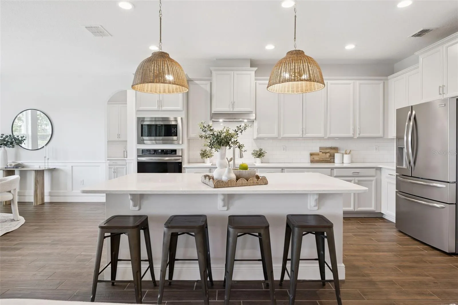 Breakfast bar island with pendant lighting, open to the dining room