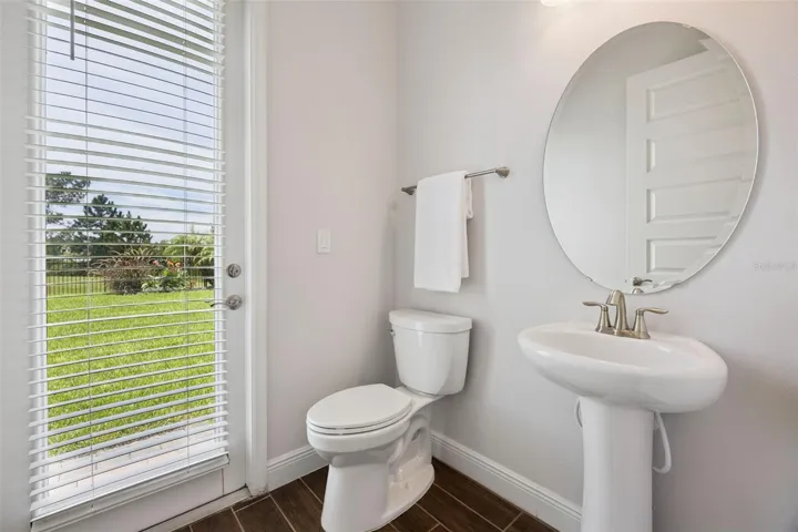 First-floor half bath with pedestal sink