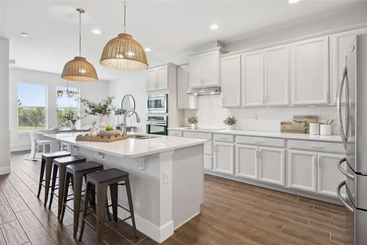 Kitchen island with pendant lighting and quartz counters