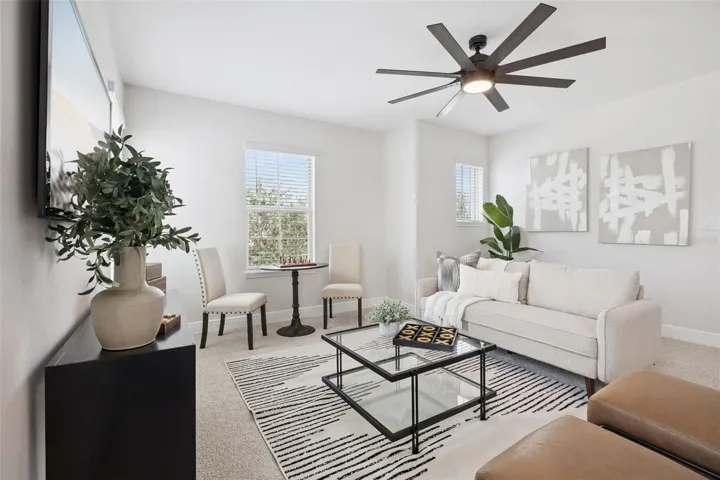 Second-floor loft with ceiling fan and natural light