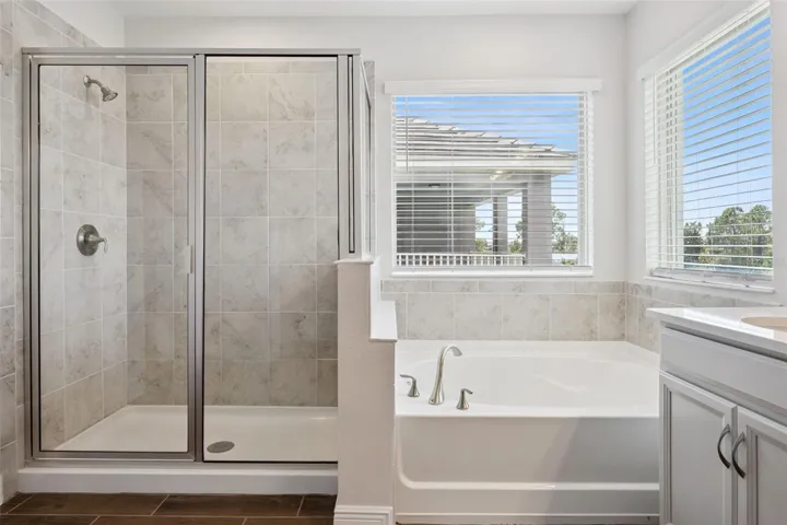 Primary bath with garden tub and glass-enclosed shower