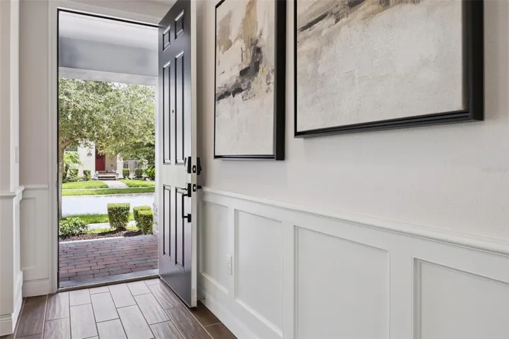 Foyer with wainscoting and wood-look tile at the front entry