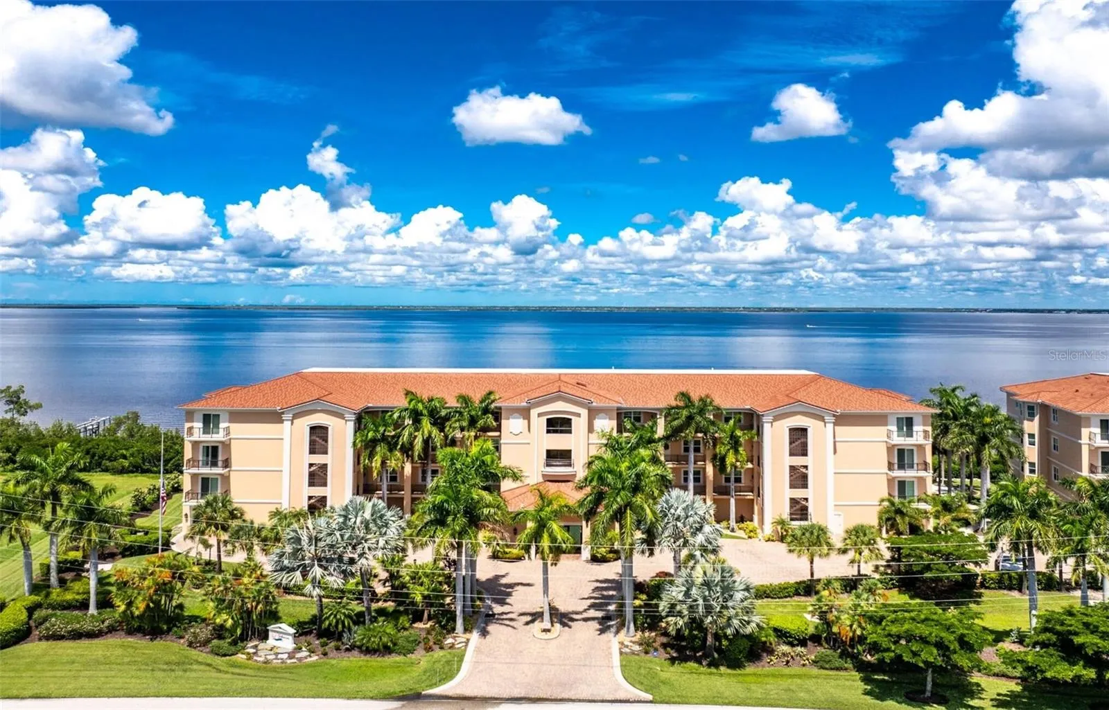 Lush tropical landscaping surround this contemporary design residing on vibrant harbor teeming with marine life and wide variety of boats activity every day