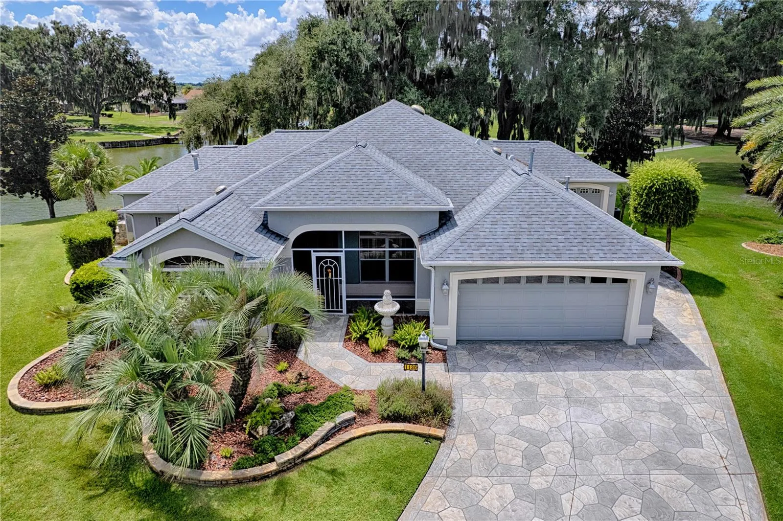 Front view of home, view of pond on back laft and golf course back right