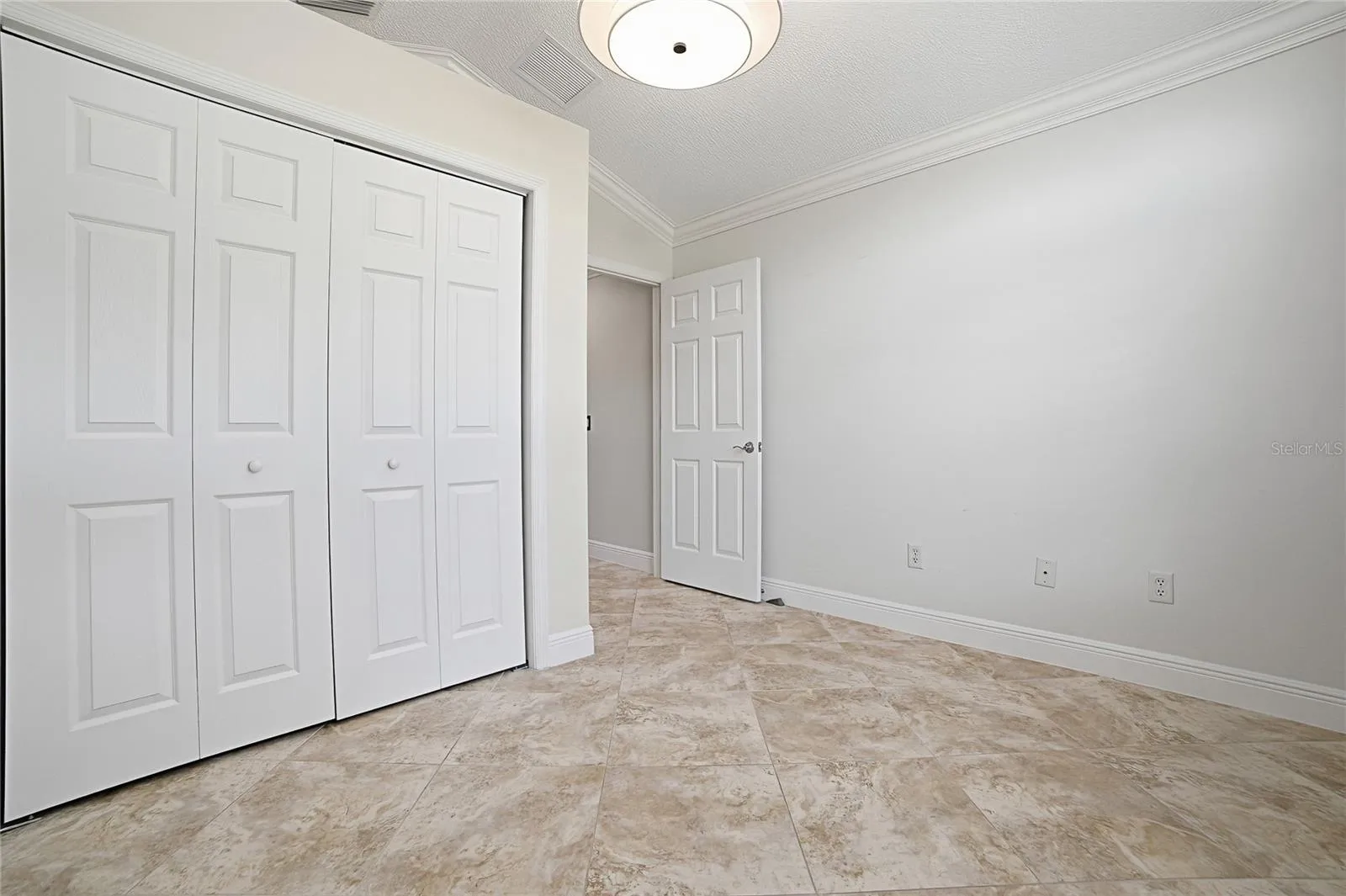 Second bedroom closet with closet system in it