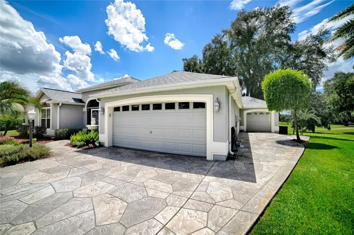 Front of garage and view of golf cart garage on front right side of house