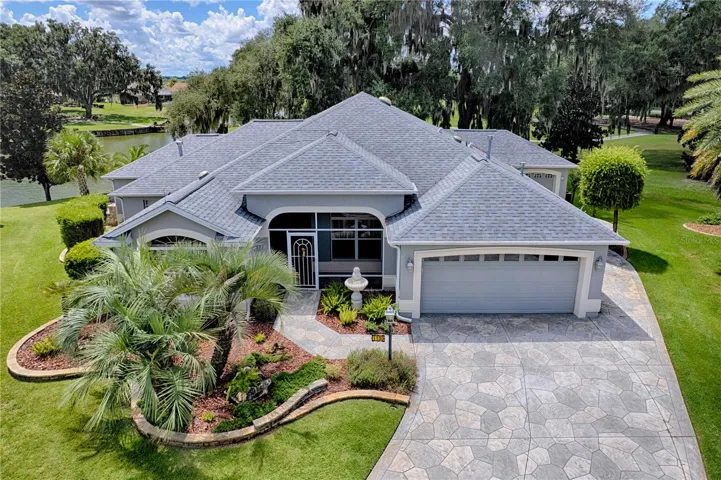 Front view of home, view of pond on back laft and golf course back right