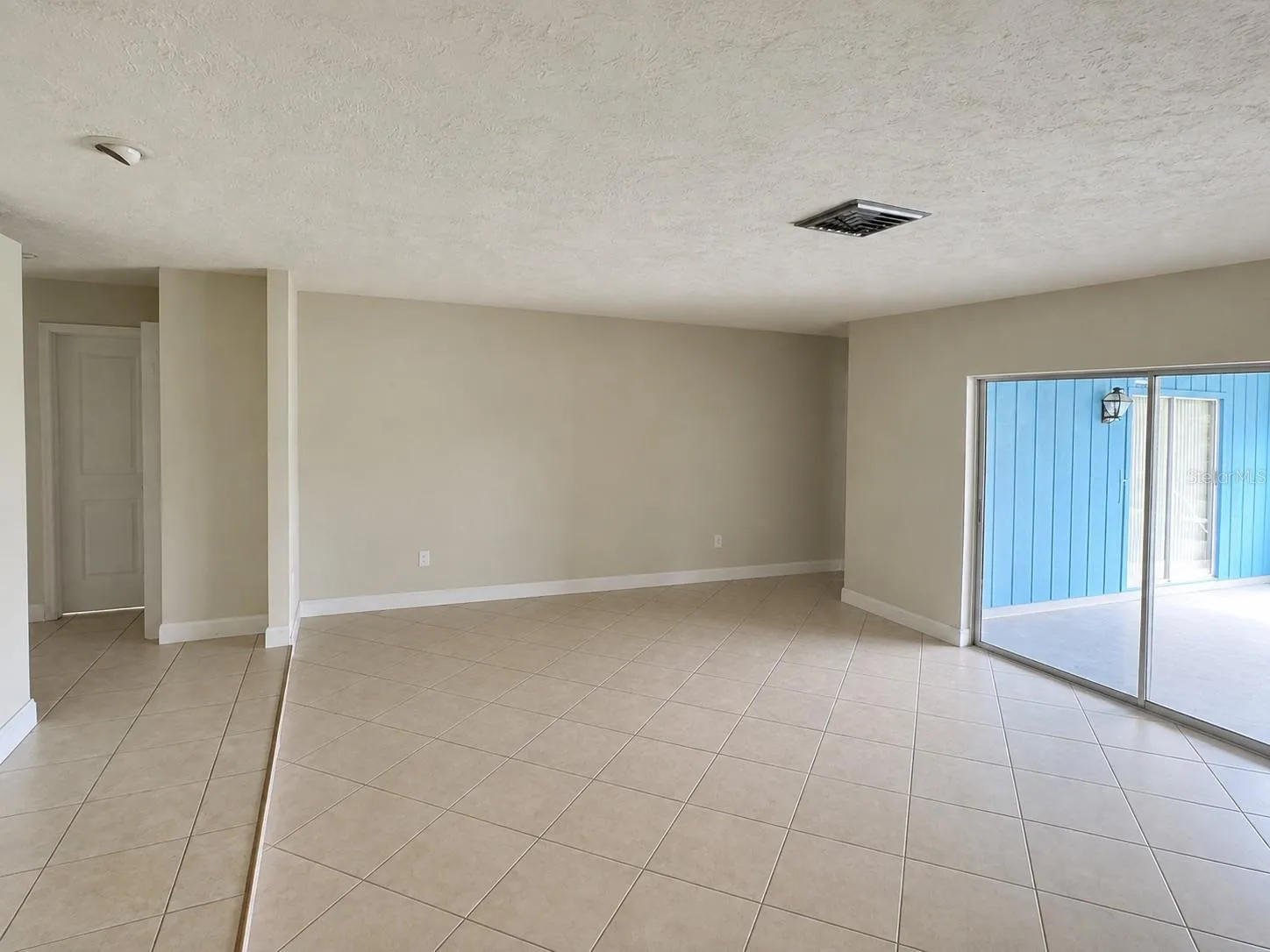 Living/dining area overlooking pool