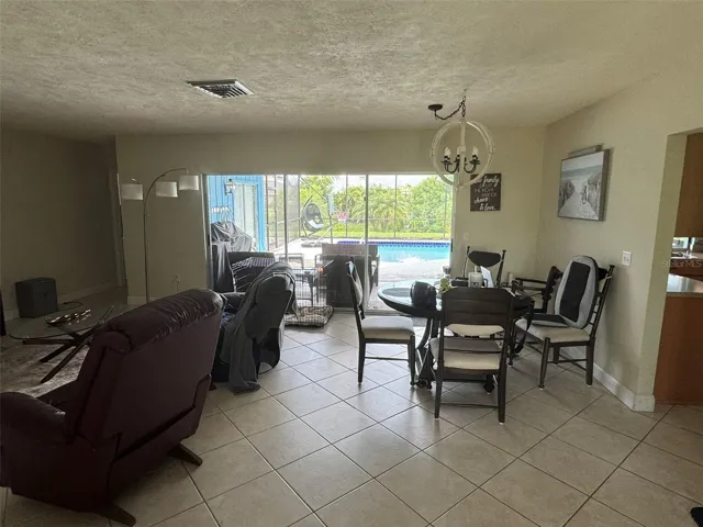 Living/dining area overlooking pool