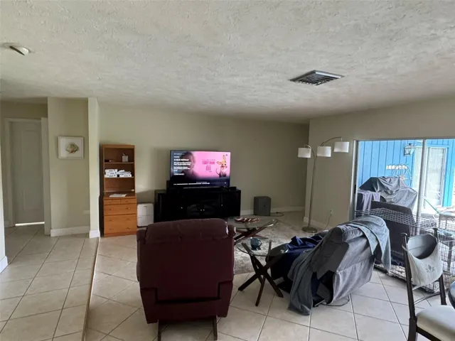 Living/dining area overlooking pool