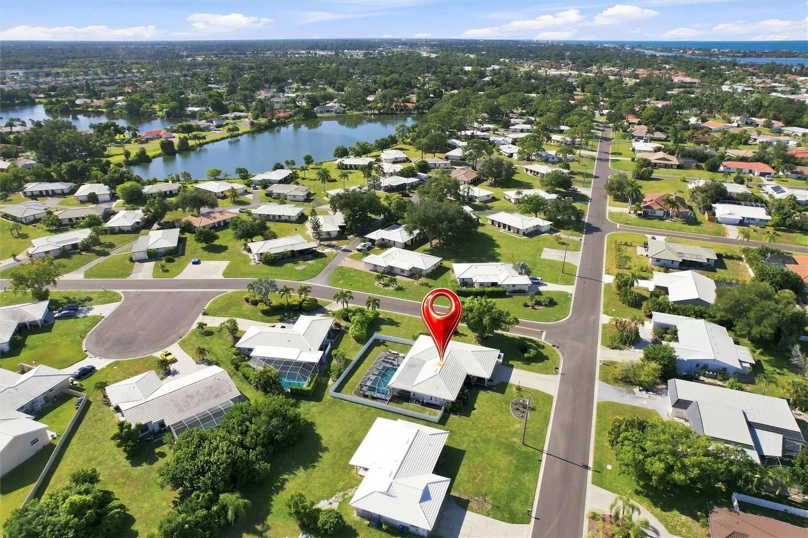 Aerial of home and neighborhood homes and lakes