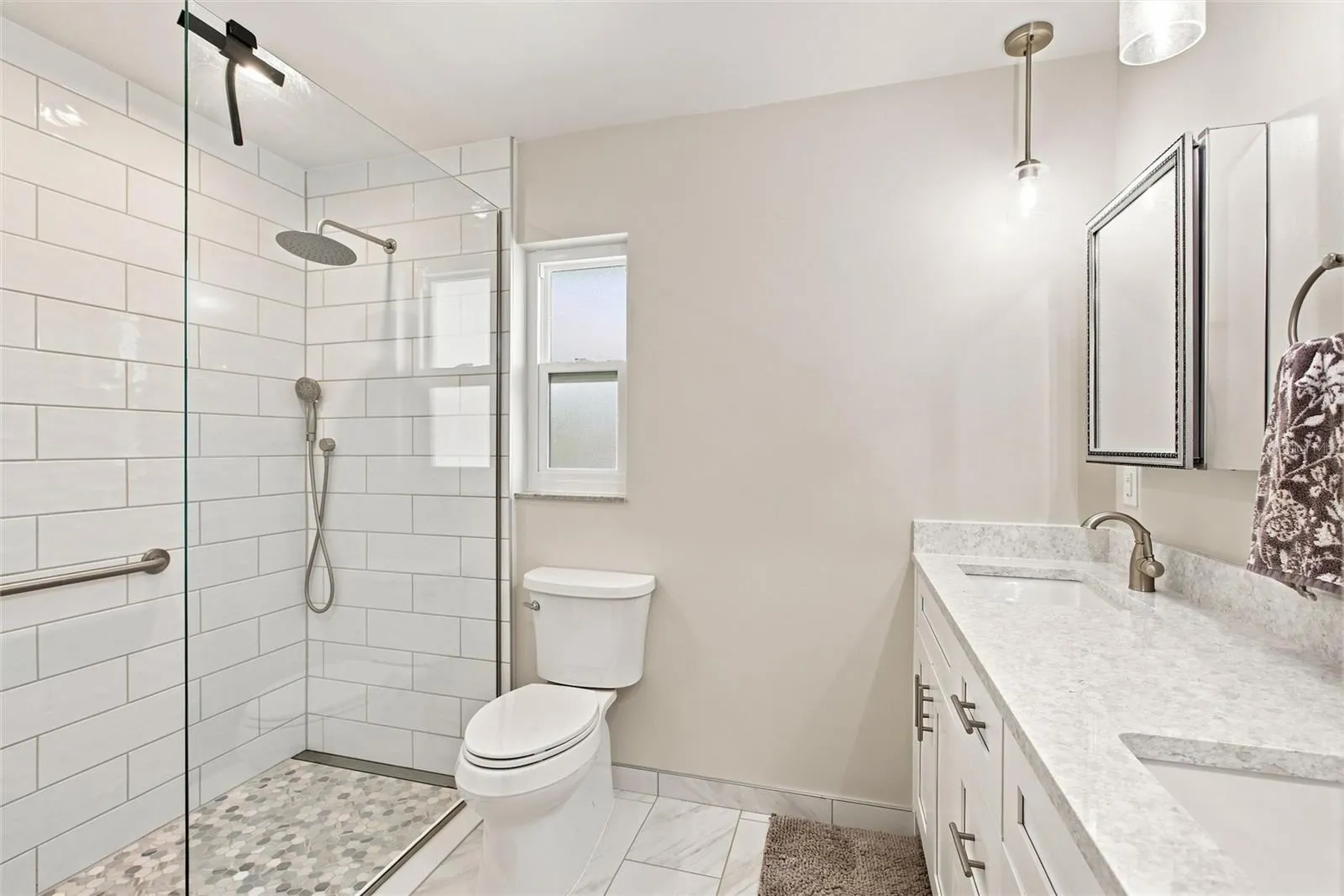 Primary En-Suite Bath with dual sinks and tile shower