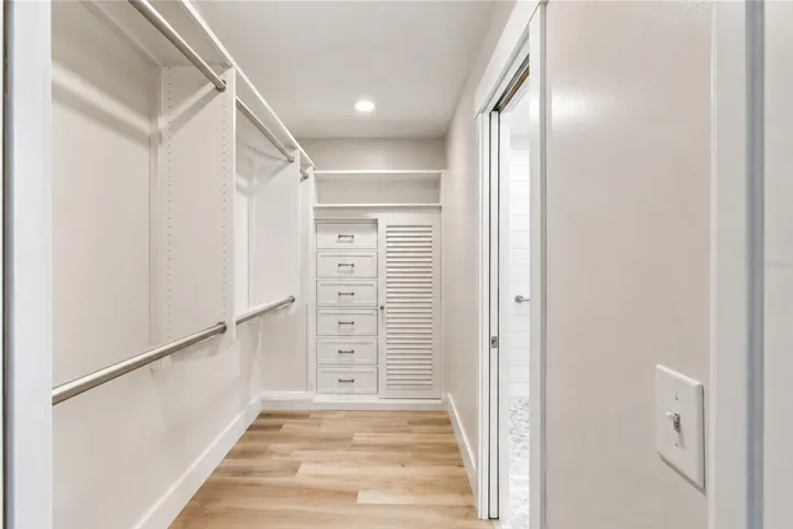 Primary bedroom walk-in closet (photo enhanced to remove items in closet)