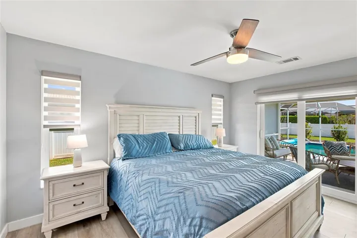 Primary Bedroom, (impact sliders leading to screened lanai and pool)