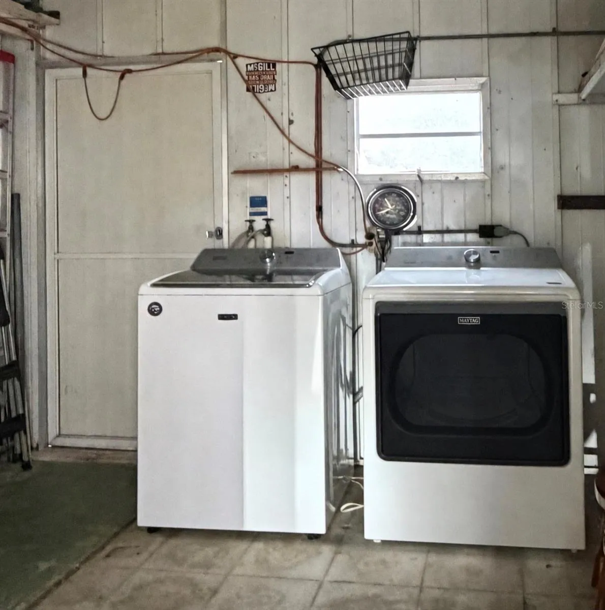 washer and dryer in shed under carport