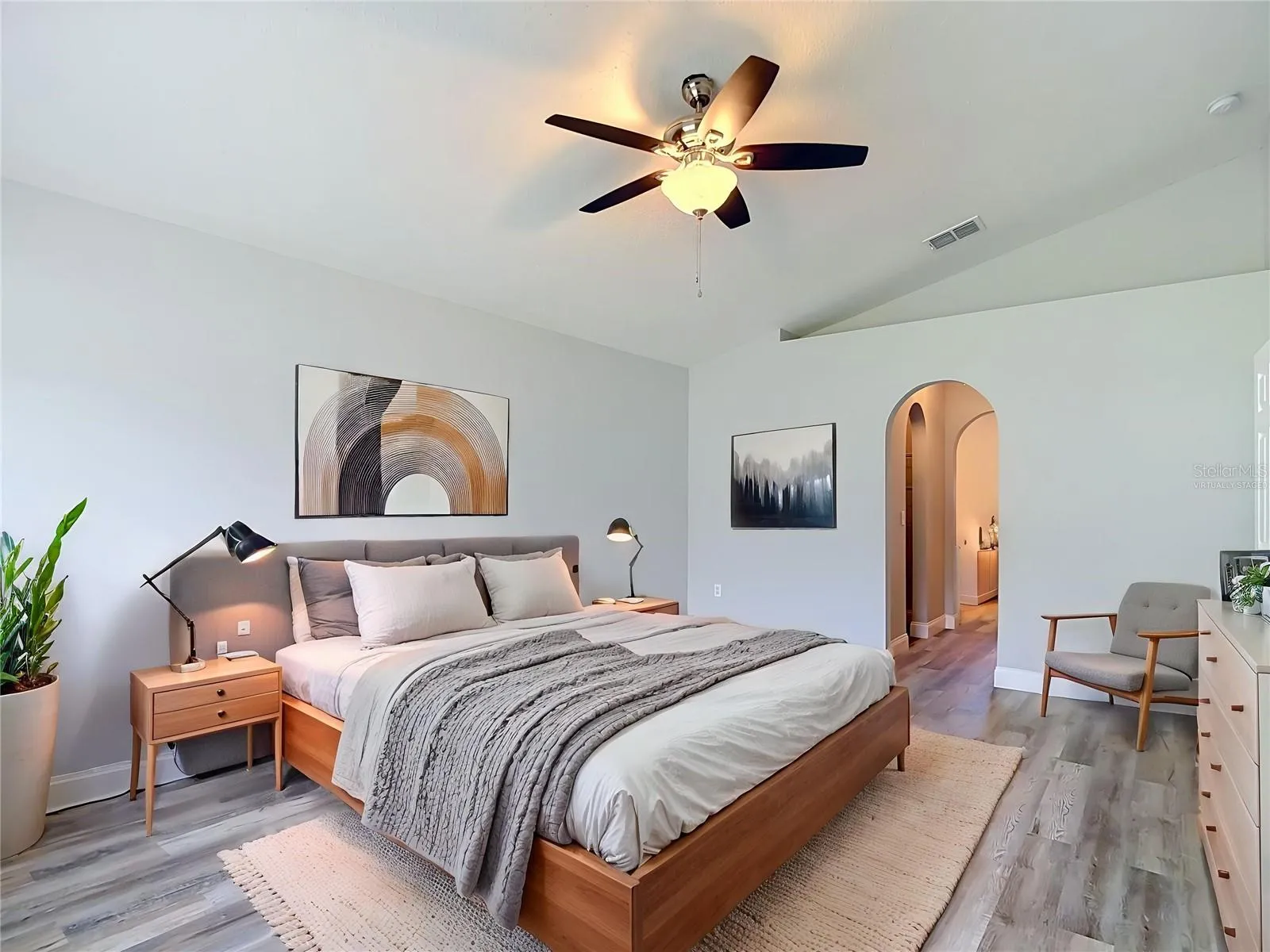 Primary bedroom with two walk-in closets and en suite bathroom - image is virtually staged